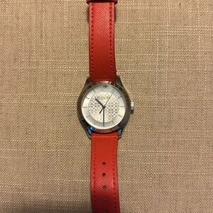 Coach women's watch, silver details, orange straps.